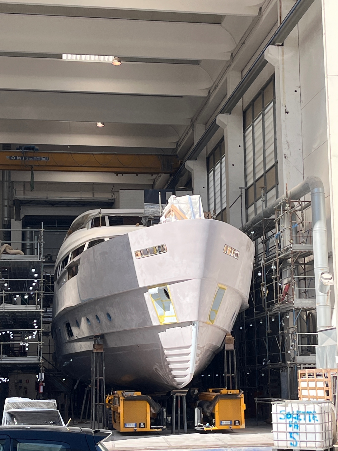 Motor yacht hull in build hall during an owner's representative shipyard inspection